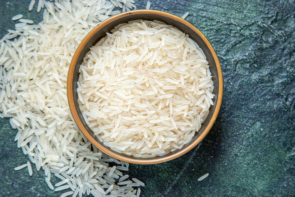 top-view-raw-rice-inside-plate-dark-desk-2-1024x683